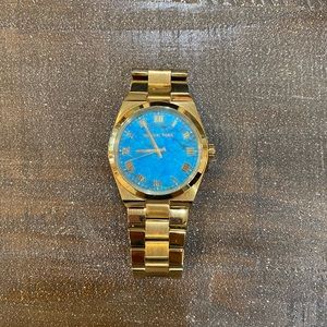Michael Kors gold watch with turquoise face.